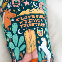 Close-up of a colorful, hand-drawn print on a two-piece long-sleeve pajama fabric.