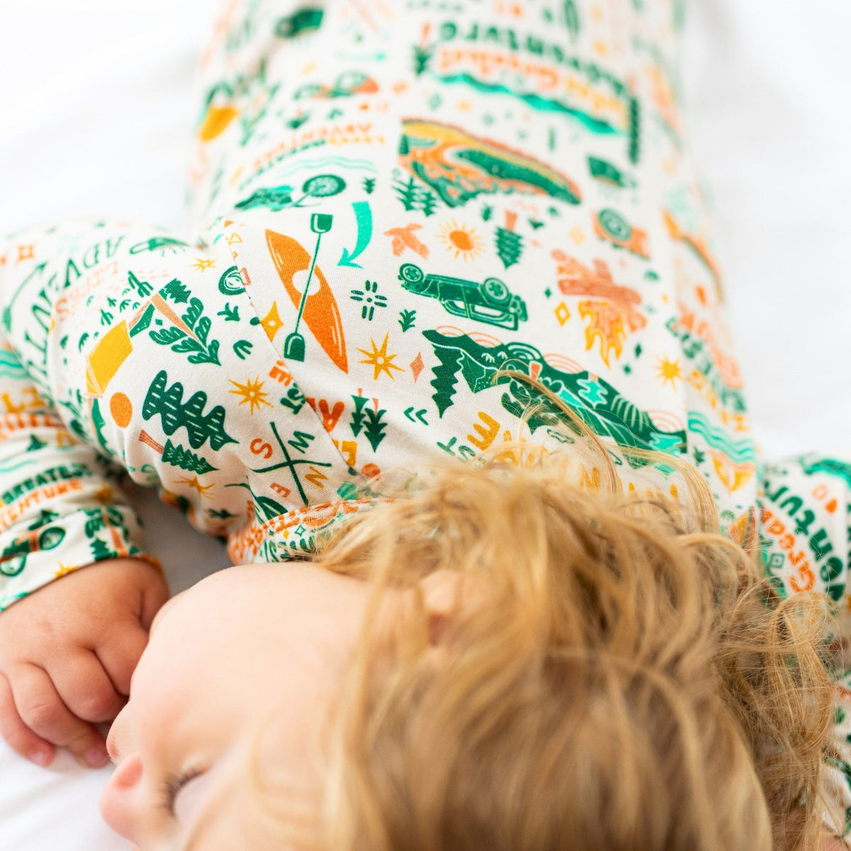 A child easily transitioning from a sleeper to play mode in the Second-Skin Toddler Convertible Romper, showcasing its adaptability.