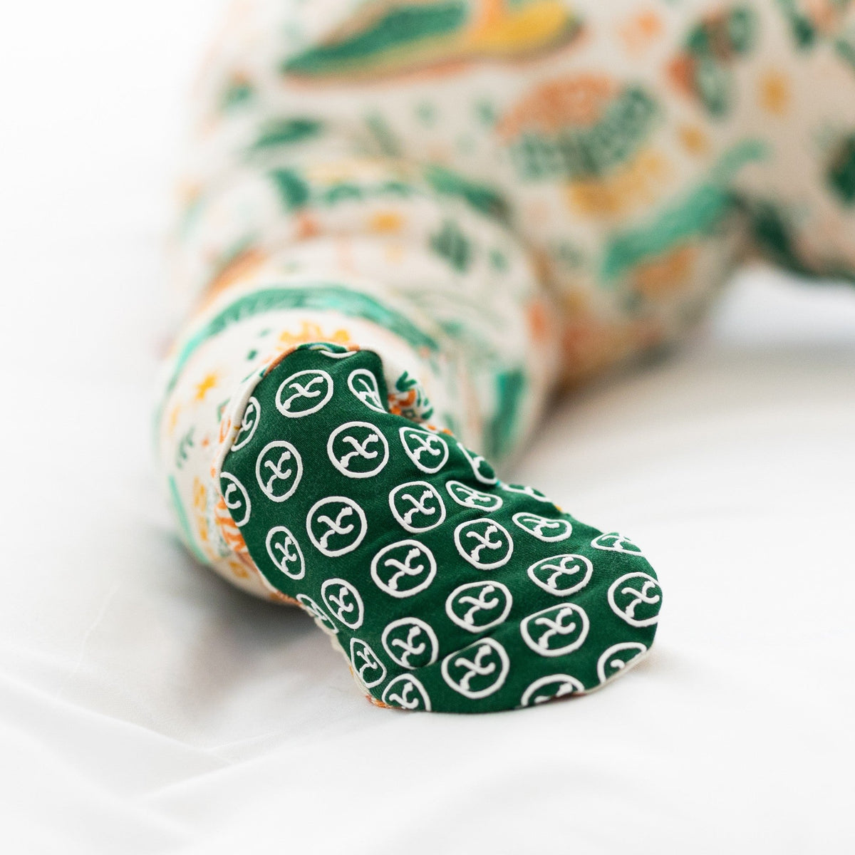 Green sock with white patterns on a white background