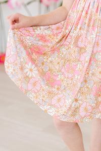 Pink floral short sleeve twirl dress with a front pocket, designed for comfortable play and easy washing.