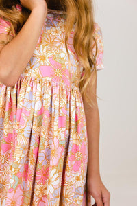 Girls pink floral short sleeve pocket twirl dress with gathered skirt, scoop back, and comfortable fit for school or play.
