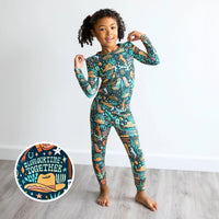 Child wearing The Second-Skin 2-piece long-sleeve pajama in Wild West print.