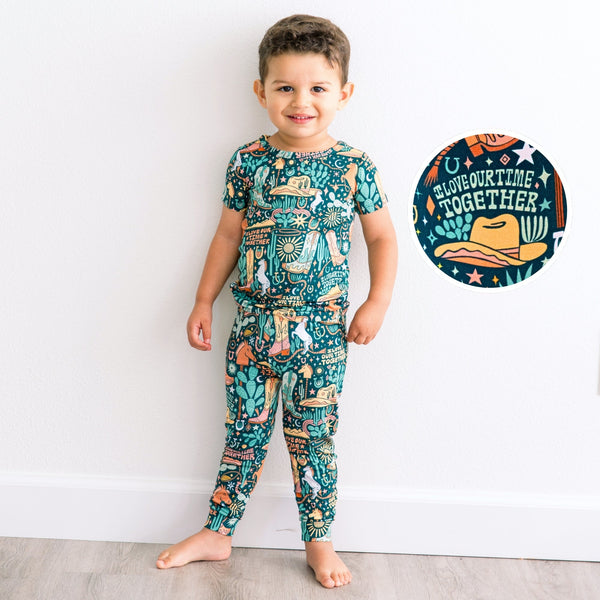 Young boy wearing The Second-Skin 2-Piece Short Sleeve Pajama in Wild West with handdrawn print I Love Our Time Together