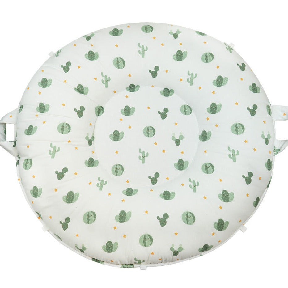 Wilder Sage Floor Cushion featuring a playful cactus and star design, perfect for children 12 months and older. The cushion is round with a soft, padded surface for comfortable playtime.