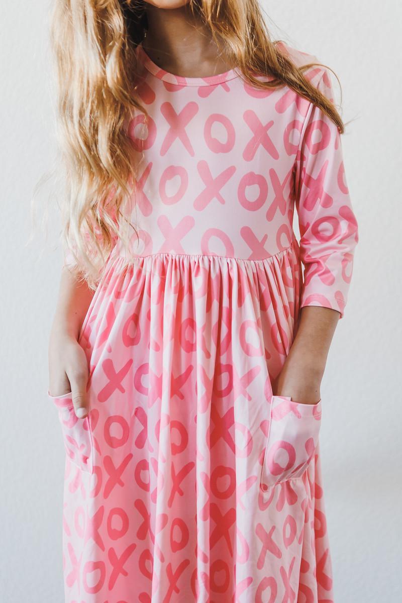 XOXO pink twirl dress with 3/4 sleeves and pockets for little girls.