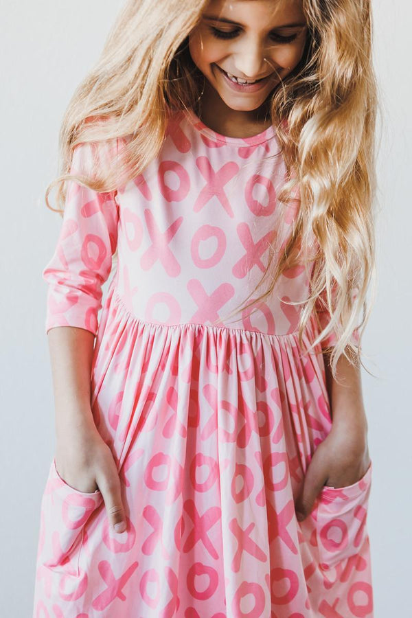 XOXO 3/4 sleeve pocket twirl dress for little girls in pink with playful XOXO print and pockets
