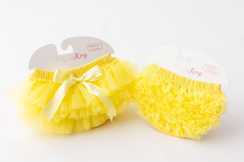 Two yellow ruffle tutu bloomers with elastic waist; one features a bow, full front-and-back ruffles.