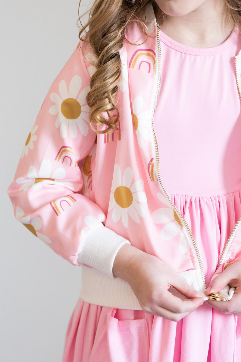 Girl adjusting the zipper of the You are My Sunshine Satin Jacket, highlighting its trendy design and soft satin fabric, great for a playful look.