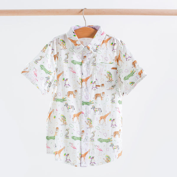 Short-sleeve shirt with animal pattern on a hanger against a white background