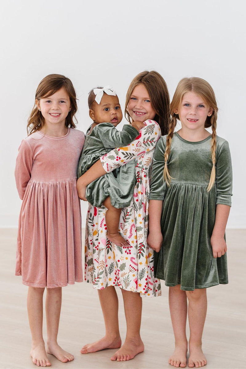 Sage Velvet Twirl Dress by Mila & Rose, highlighting a group of four children, including a baby, wearing elegant dresses in various colors, including the chic sage green twirl dress.