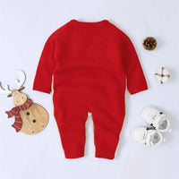Red reindeer knit romper for babies made of soft knitted material shown with white baby shoes