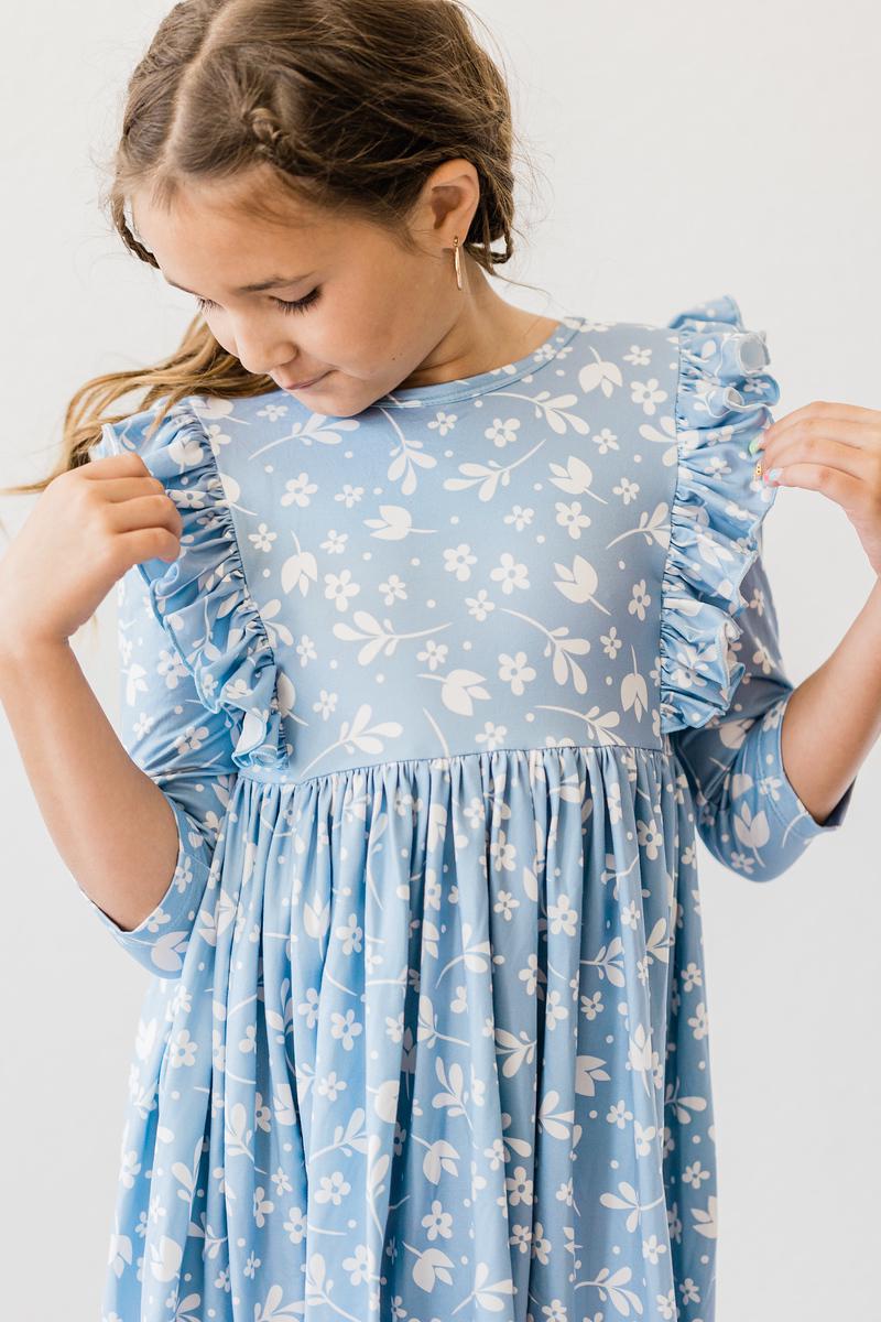 Close-up of the Bluebell 3/4 Sleeve Ruffle Twirl Dress by Mila & Rose, showcasing its soft fabric and stylish design.
