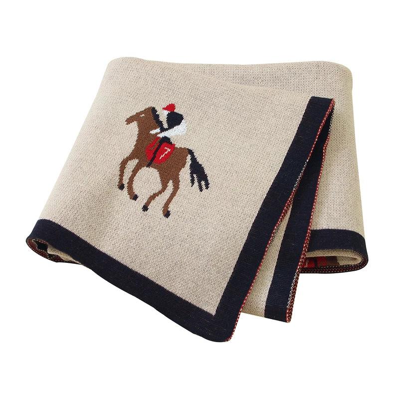 Beige animal baby blankets for babies featuring a horse and jockey design with navy border