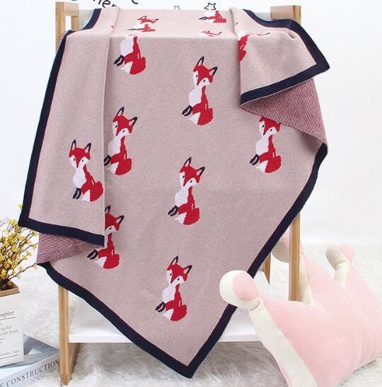 Pink animal knit baby blanket with red fox pattern for babies featuring navy border detail