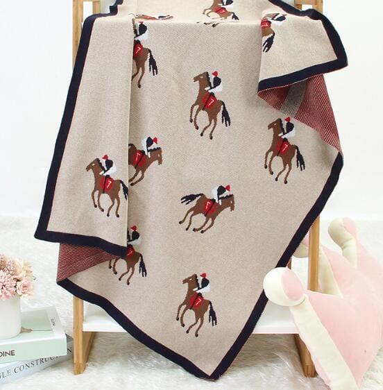 Beige animal knit baby blanket with horse and rider pattern, perfect for newborns and infants