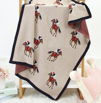Beige animal knit baby blanket with horse and rider pattern, perfect for newborns and infants