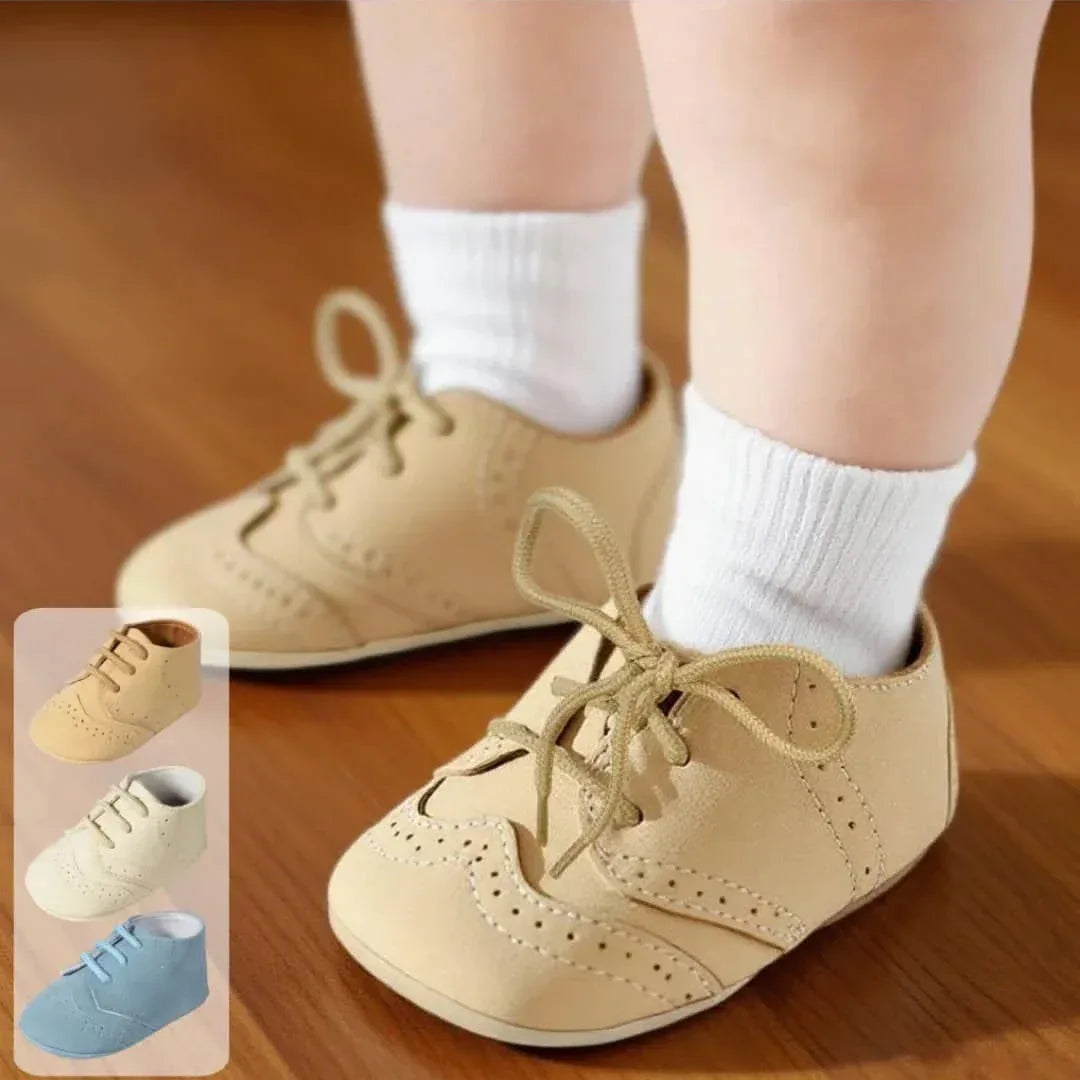 baby wearing beige anti-slip baby shoes for boys while standing on wooden floor