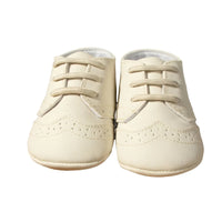 Cream anti-slip baby shoes for boys in small size shown from front view