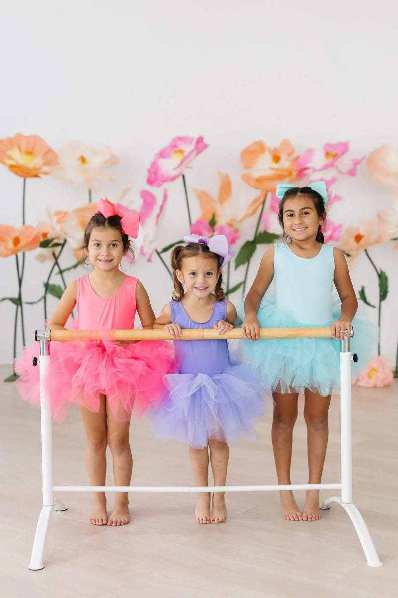 Girls aqua tutu leotard for girls tank style worn by child at ballet barre with floral background