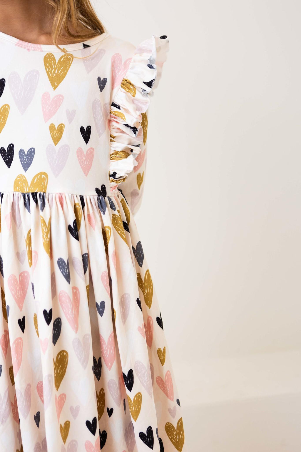 I Heart You 3/4 Sleeve Ruffle Twirl Dress featuring colorful heart patterns and ruffled sleeves, perfect for stylish girls.