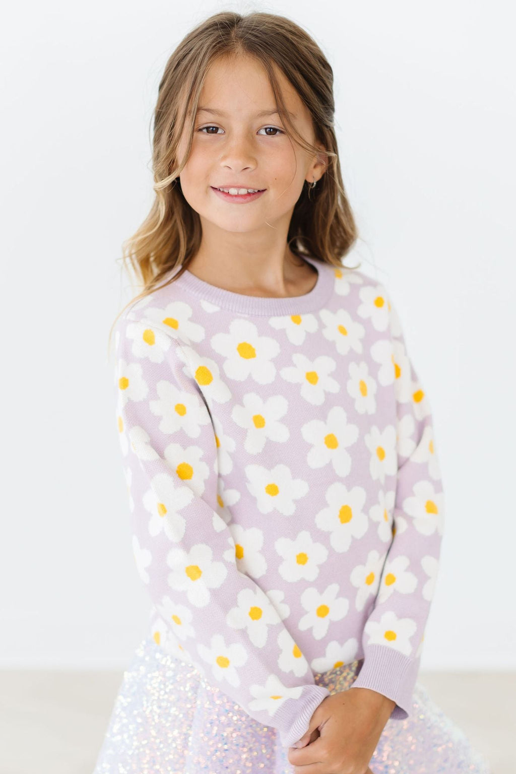 Charming girl modeling the Love You Bunches Sweater by Mila & Rose ®, featuring a playful floral design, perfect for cozy winter styles.