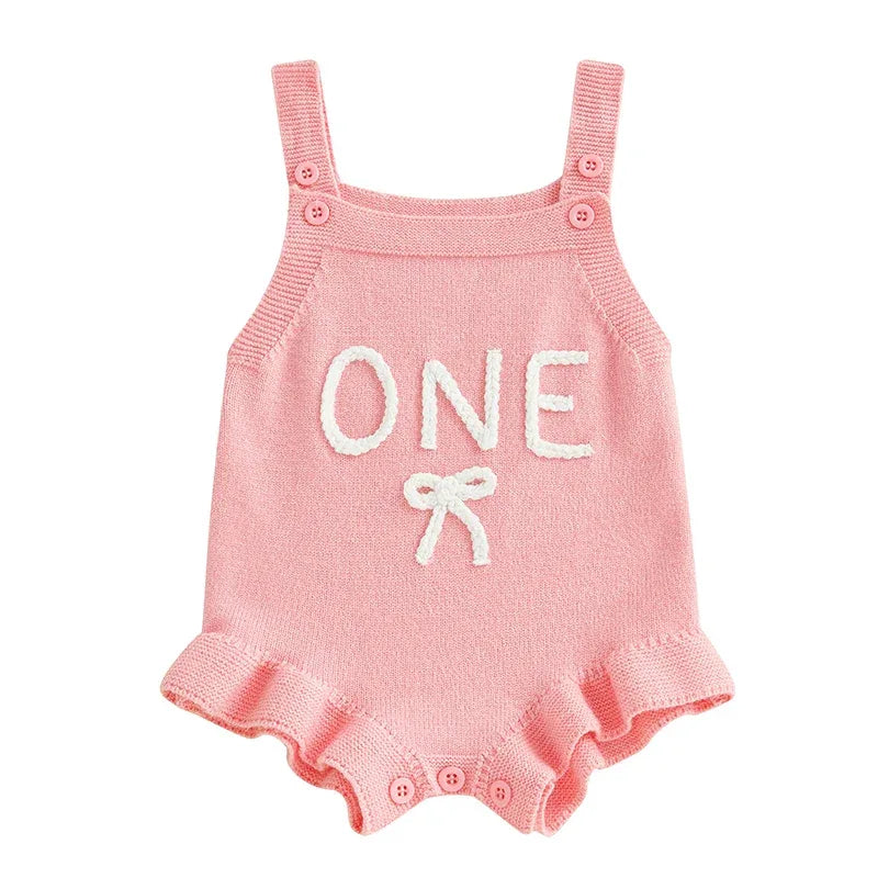 pink baby birthday romper for one year old with 'ONE' text and ruffle trim