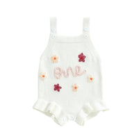 White baby birthday romper with pink one embroidery and multicolor flower details for infants