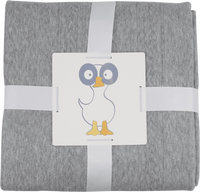 Soft gray knit baby blanket made from cozy material, neatly folded with a duck illustration tag