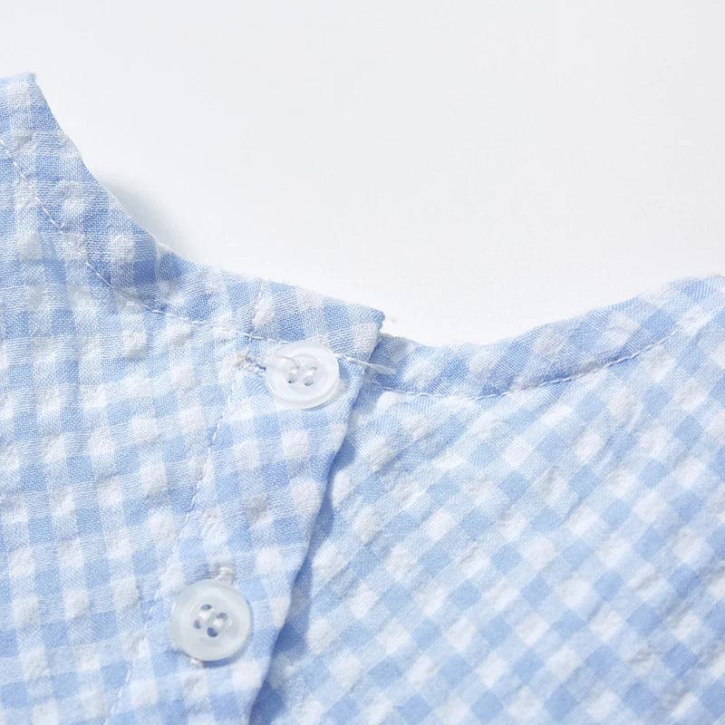 baby blue gingham party dress close-up showing white buttons and collar detail