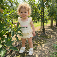 cream baby girl outfit with pink flower embroidery and ruffled sleeves for toddler size