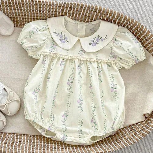 Cream baby bubble rompers with floral print and embroidered collar for infants