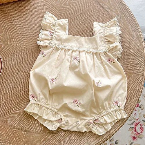 Cream baby bubble rompers with pink floral embroidery and ruffle sleeves for infants