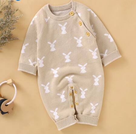 Beige baby bunny knit romper for infants with white bunny pattern and button details
