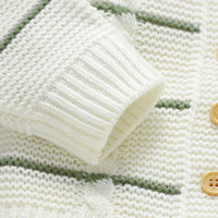 Cream and green knit baby cardigan with wooden buttons and textured sleeve cuff baby cardigan and overalls outfit