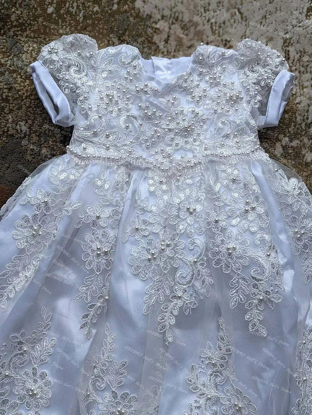 White baby christening gown with bonnet featuring lace and pearl details for newborns