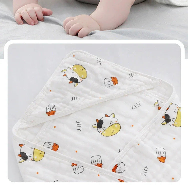 White baby envelope wrap with yellow and black cow print and orange details for newborns and infants