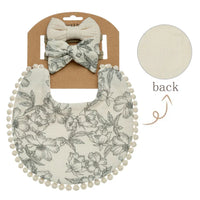 Neutral baby flower bib and headband set with floral print and pom pom trim for infants
