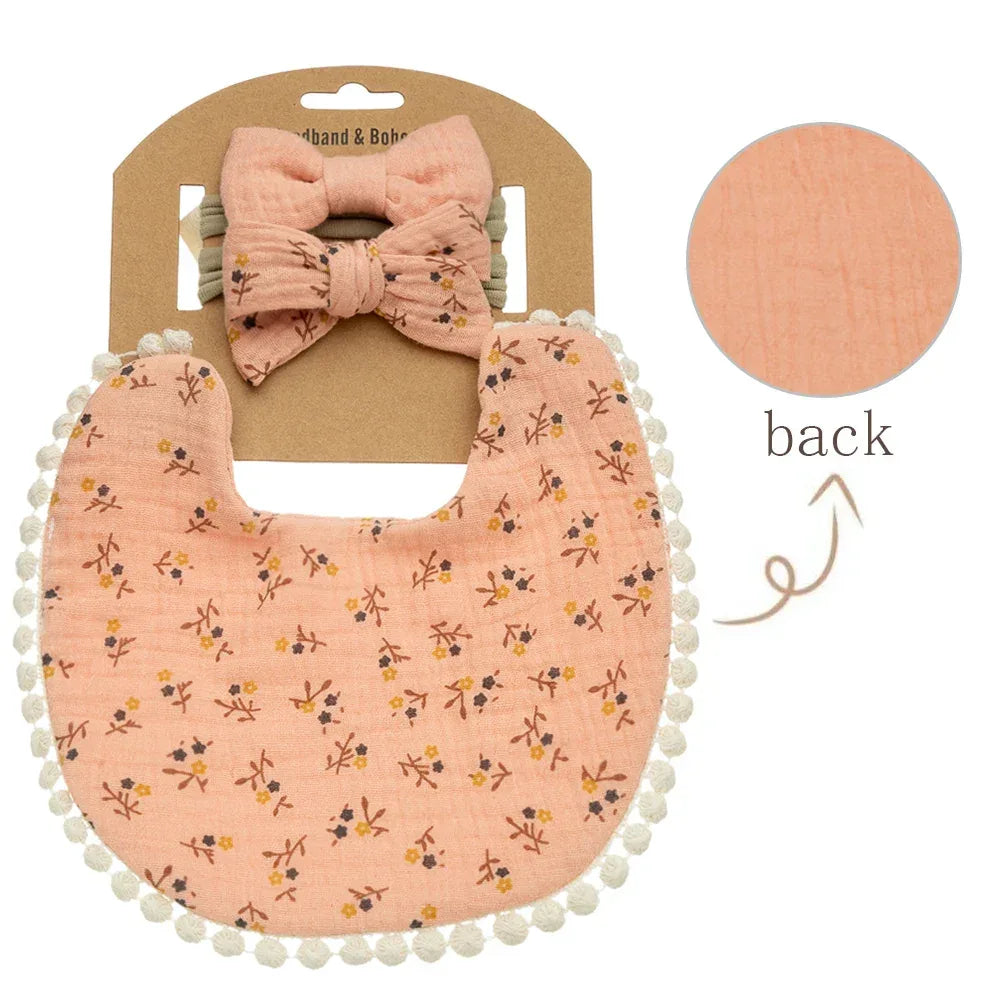Peach baby flower bib and headband set with floral print and pom pom trim for infants
