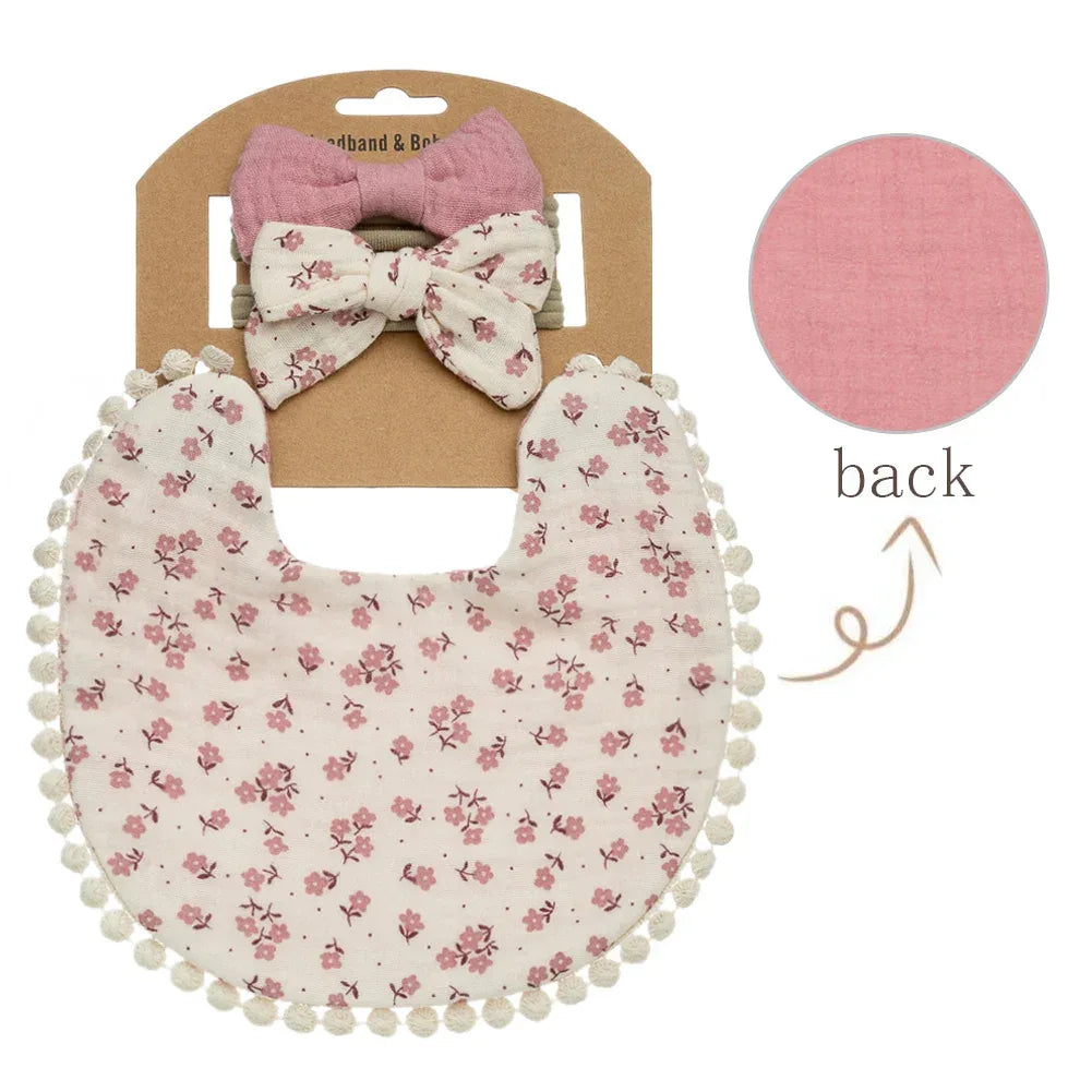 Baby flower bib and headband set with pink floral print and pompom trim for infants