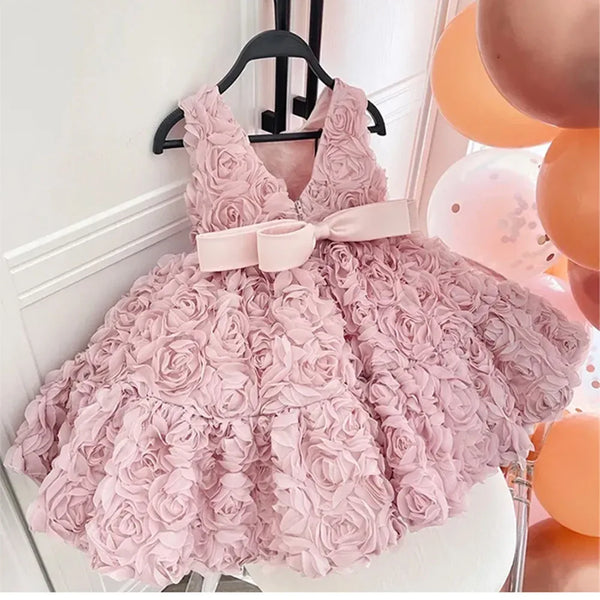 Pink baby girl party dress with 3D rose floral design and bow detail for toddlers