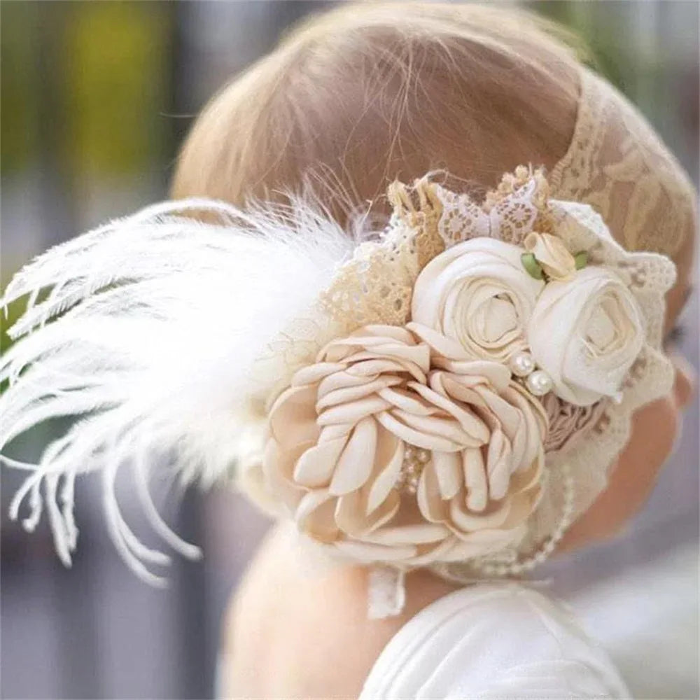 cream and white floral baby headpieces with lace and feather detail for infants