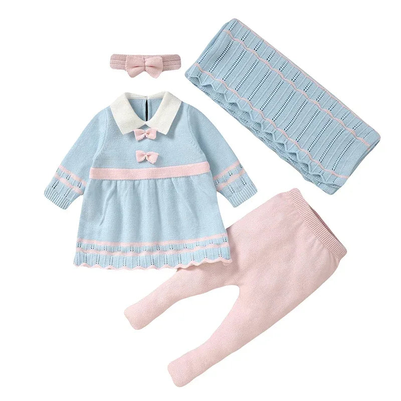 Baby blue knit dress with white collar and pink bows, pink knit pants, matching headband and baby blanket