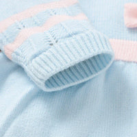 Baby blue knit dress with pink accents, soft knit fabric for infants, delicate sleeve cuff detail