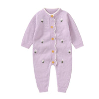 Lilac baby knit romper with flower design made of soft knitted fabric with wooden buttons