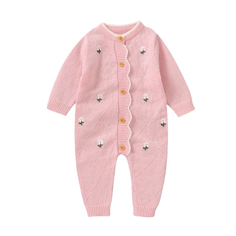 Pink cotton baby knit romper with flower design featuring long sleeves and wooden buttons