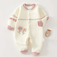 Cream baby knitted flower romper with pink trim made of soft knit fabric for infants