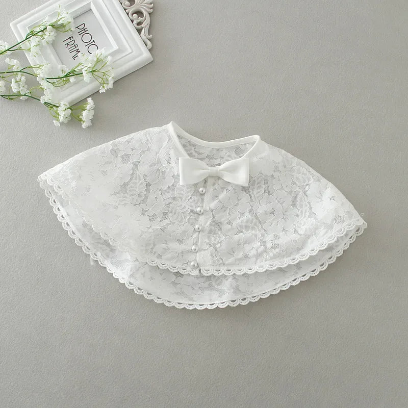white baby lace special occasion dress cape with bow and pearl button details for infants