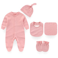 Pink baby layette set including footed sleeper, hat with knot, bib, washcloth, and mittens for newborns