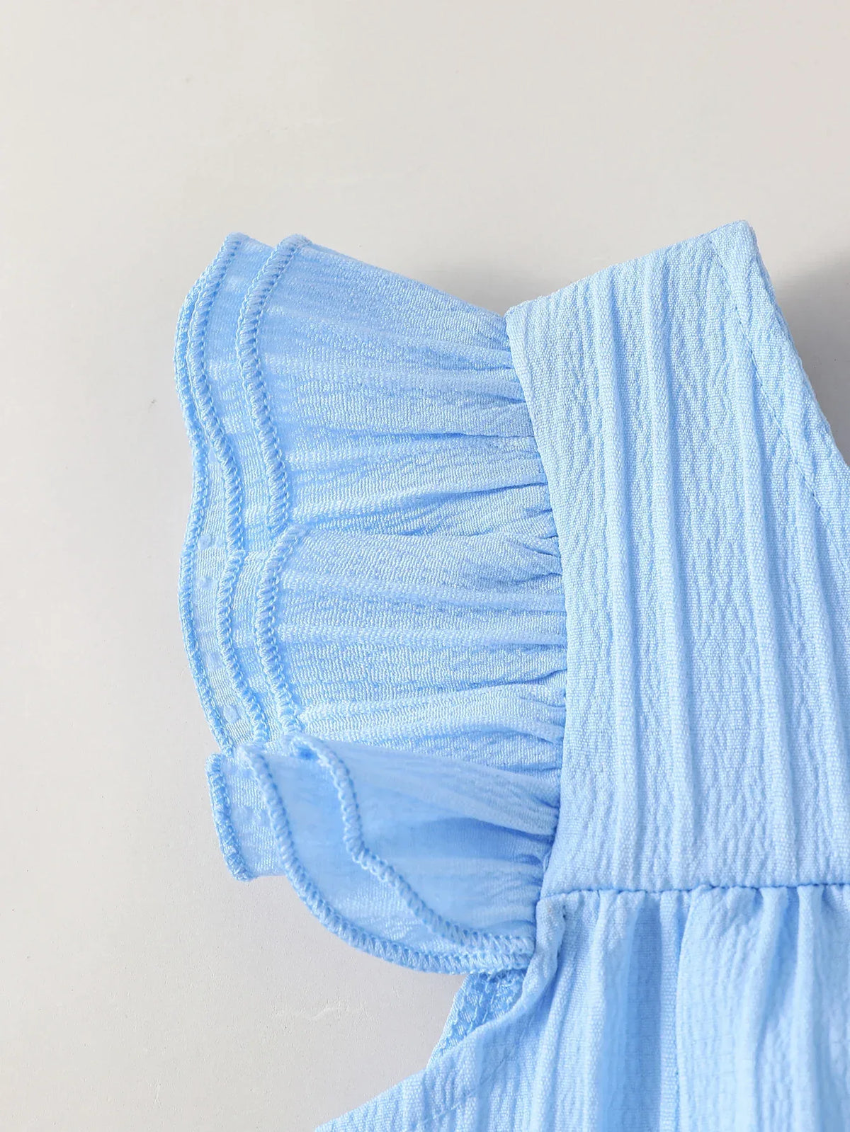 Light blue party pants set for babies with ruffled short sleeves and textured fabric