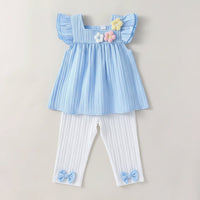 Sweet Sue 2 Piece Party Pants Set featuring a light blue top with ruffled sleeves and crocheted flowers, paired with white elasticized pants adorned with cute blue bows, perfect for young girls aged 18 months to 6 years.